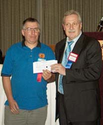 Colin Cutler receiving the Louise Graham Club of the Year on behalf of the Windsor Coin Club from Chuck Moore